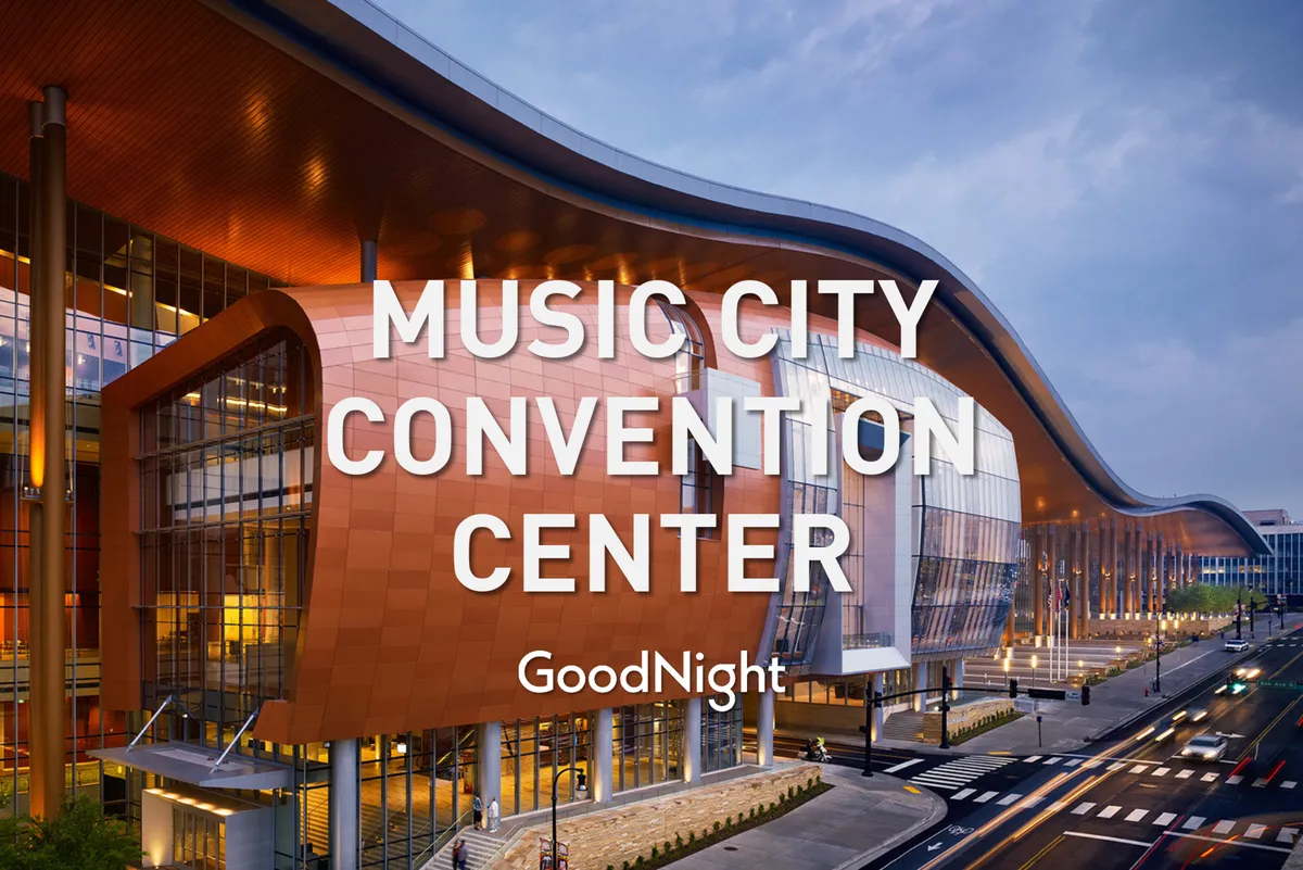 The exterior of the Music City Convention Center, featuring its striking curved architecture, expansive glass windows, and bold colors. The scene is lively, hinting at the energetic buzz of conventions and large gatherings.