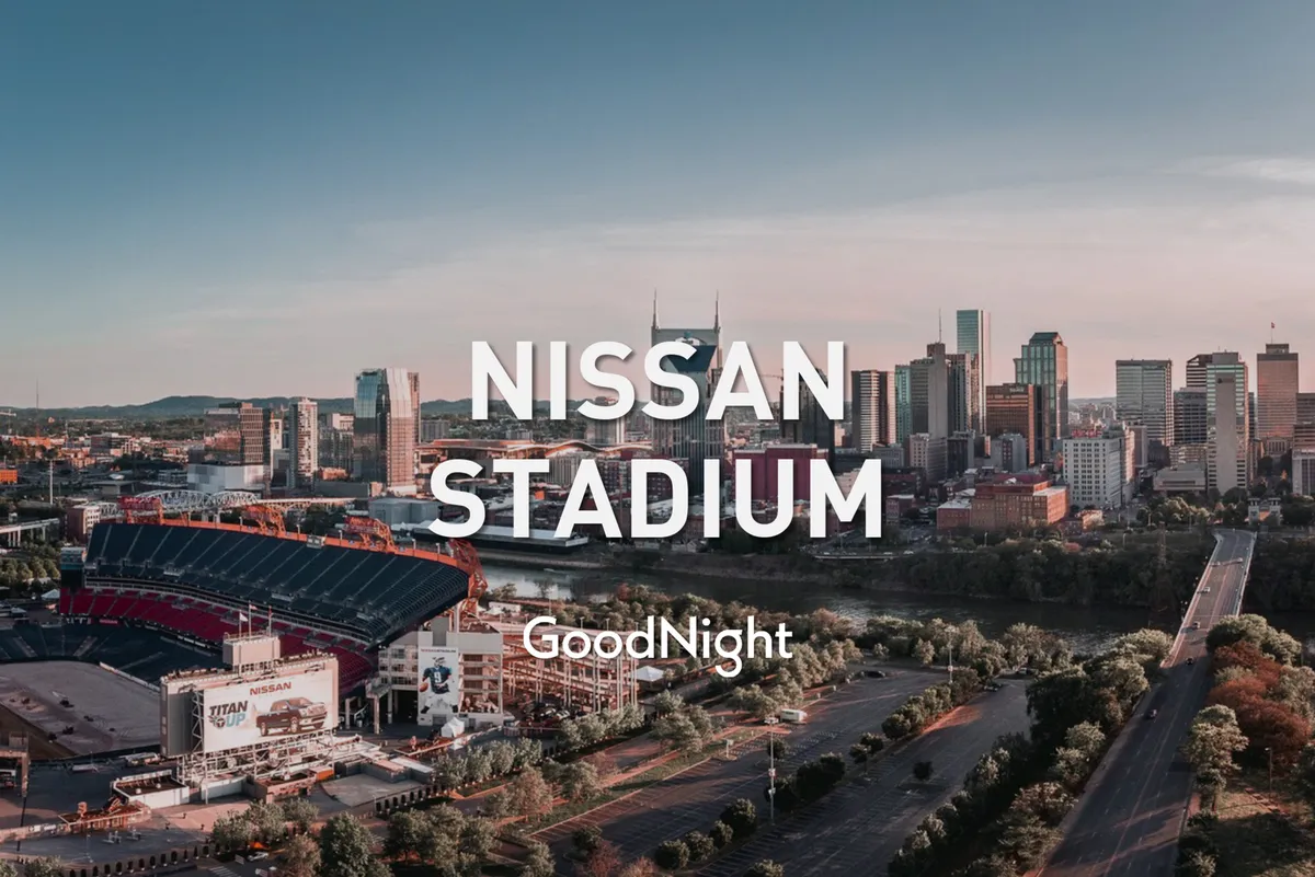 A broad view over Nissan Stadium, looking out to the Nashville skyline and riverway. The cityscape stretches across the horizon, suggesting opportunities for city exploration and social events in a lively urban setting.
